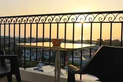 a table with a cup on top of a balcony at Planet View in Faliraki