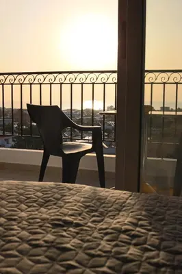 a chair sitting on top of a bed in a room at Planet View in Faliraki