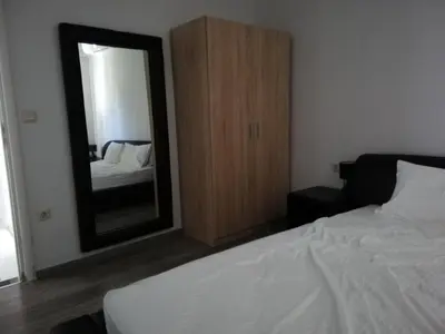 a bedroom with a bed and a large mirror at CASA DE MIKEL 2 in Rhodes Town