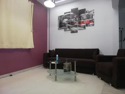a living room with a couch and a table at CASA DE MIKEL 2 in Rhodes Town