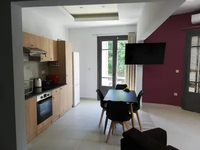 a kitchen with a table and chairs in a room at CASA DE MIKEL 2 in Rhodes Town
