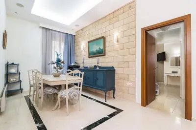 a dining room with a table and a desk at La Casa di Efi in Rhodes Town