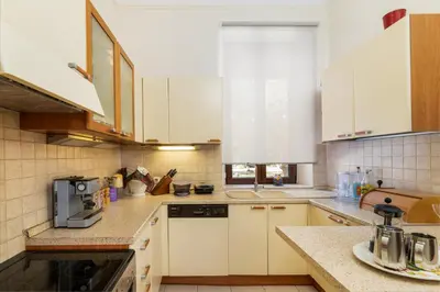 a kitchen with white cabinets and a counter top at La Casa di Efi in Rhodes Town