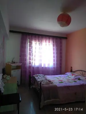 a bedroom with a bed and a window with pink curtains at Home sweet home in Rhodes Town