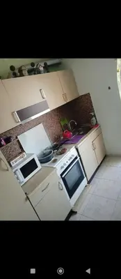 a small kitchen with a stove and a microwave at Home sweet home in Rhodes Town