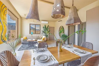 a dining room with a table and chairs at Gaia Blue Villa in Kolimbia