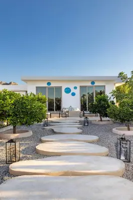 a building with a row of stone pathways in front of it at Gaia Blue Villa in Kolimbia