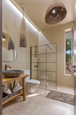 a bathroom with a toilet and a glass shower at Gaia Blue Villa in Kolimbia