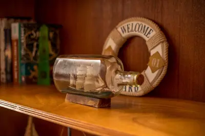 a glass bottle sitting on top of a shelf at Kelly's Beach House 1 in Gennadi