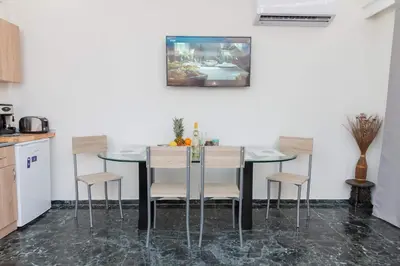 a kitchen with a table and four chairs at AS SUITES ROOM 14 in Rhodes Town
