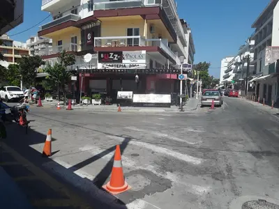 an empty street with orange cones in front of a building at AS SUITES ROOM 14 in Rhodes Town