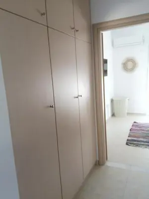 a room with white cabinets and a hallway at Sable Blanc Apartments in Ixia