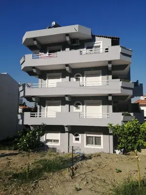 a tall white building on top of a hill at Sable Blanc Apartments in Ixia