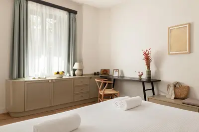 a bedroom with a bed and a desk and a window at Casa Natura in Rhodes Town