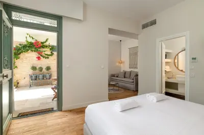 a bedroom with a bed and a living room at Casa Natura in Rhodes Town