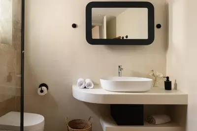 a bathroom with a sink and a mirror on the wall at Casa Natura in Rhodes Town