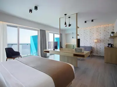 a hotel room with a bed and a desk with a television at Aquarium View Hotel in Rhodes Town