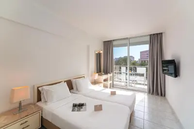 a hotel room with two beds and a window at Aquarium View Hotel in Rhodes Town