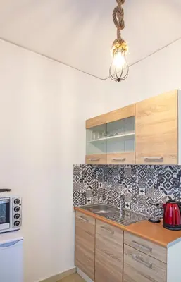 a kitchen with a sink and a stove top oven at CHAMBRE BLEUE in Ialyssos