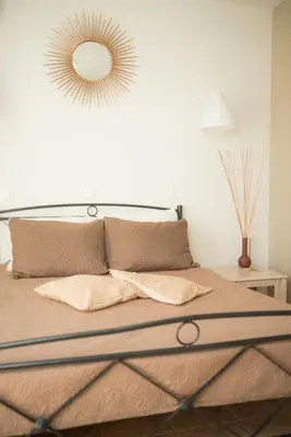 a bedroom with a bed with a mirror on the wall at Kampus Living Luxury Complex in Faliraki
