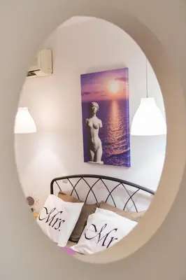 a room with a bed with a picture of the ocean at Kampus Living Luxury Complex in Faliraki