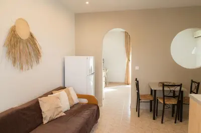 a living room with a couch and a table at Kampus Living Luxury Complex in Faliraki