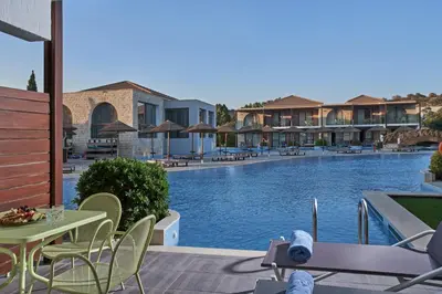 a view of a pool at a resort with a table and chairs at Atlantica Holiday Village Rhodes in Kolimbia