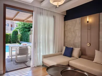 a living room with a couch and a table at Atlantica Holiday Village Rhodes in Kolimbia