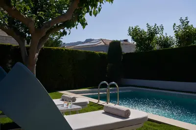 a backyard with a swimming pool with a table and a sink at Atlantica Holiday Village Rhodes in Kolimbia