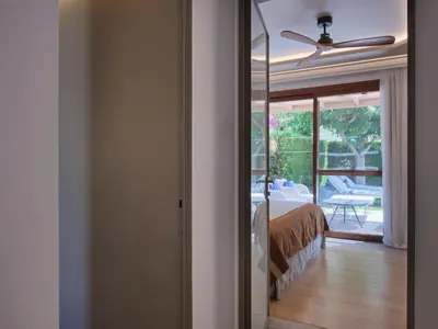 a bedroom with a bed and a ceiling fan at Atlantica Holiday Village Rhodes in Kolimbia