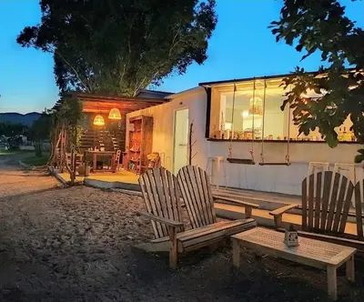 a couple of chairs sitting in front of a house at Eco Beach And Magic Garden Hotel in Gennadi