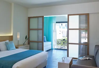 a hotel room with a bed and a couch at Atlantica Plimmiri in Plimmiri