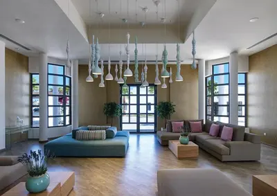 a living room with couches and tables and windows at Atlantica Plimmiri in Plimmiri