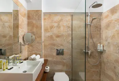 a bathroom with a shower and a sink at Belmare Hotel in Lardos