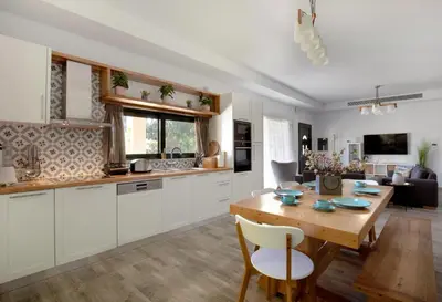 a kitchen and living room with a wooden table at Heliophos Villa Aitheria in Kiotari