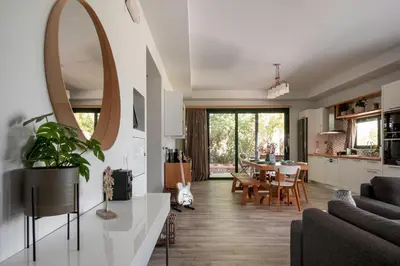 a living room with a table and a mirror at Heliophos Villa Aitheria in Kiotari