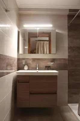 a bathroom with a sink and a mirror at Main square apartment in Symi