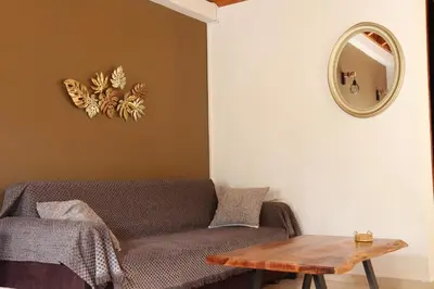 a living room with a couch and a table at Main square apartment in Symi