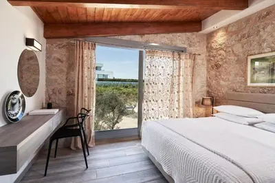 a bedroom with a bed and a desk and a window at Luxury Rhodes Villa Amel Villa Sea View Private Swimming Pool in Rhodes Town