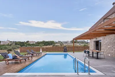 a swimming pool on a deck next to a house at Luxury Rhodes Villa Amel Villa Sea View Private Swimming Pool in Rhodes Town