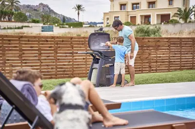 a man and two children and a dog by a pool at Luxury Rhodes Villa Amel Villa Sea View Private Swimming Pool in Rhodes Town