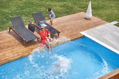 two children are playing in a swimming pool at Luxury Rhodes Villa Amel Villa Sea View Private Swimming Pool in Rhodes Town