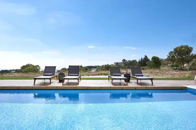 a group of lounge chairs and a swimming pool at Luxury Rhodes Villa Amina Villa Sea View Private Swimming Pool in Rhodes Town