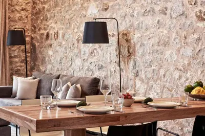 a dining table with wine glasses and a couch at Luxury Rhodes Villa Anissa Villa Sea View Private Swimming Pool in Rhodes Town