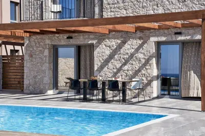 a patio with a table and chairs next to a pool at Luxury Rhodes Villa Anissa Villa Sea View Private Swimming Pool in Rhodes Town
