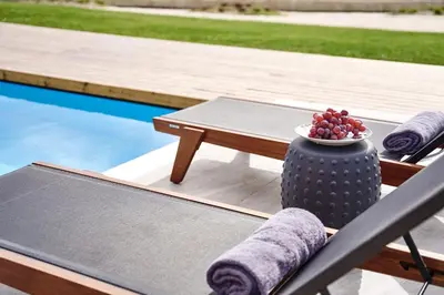 a table and chairs next to a pool with a bowl of fruit at Luxury Rhodes Villa Anissa Villa Sea View Private Swimming Pool in Rhodes Town