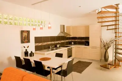 a kitchen with a table and chairs in a room at Executive Rhodes Villa 4 Bedroom 4 Bathroom Bd Villa Pefkos in Pefki Rhodes