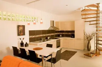 a kitchen with a table and chairs in a room at Executive Rhodes Villa 4 Bedroom 4 Bathroom Bd Villa Pefkos in Pefki Rhodes
