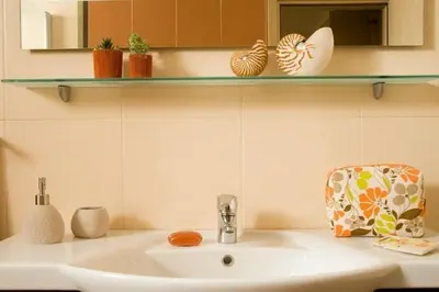 a bathroom with a sink and a shelf with plants at Executive Rhodes Villa 4 Bedroom 4 Bathroom Bd Villa Pefkos in Pefki Rhodes