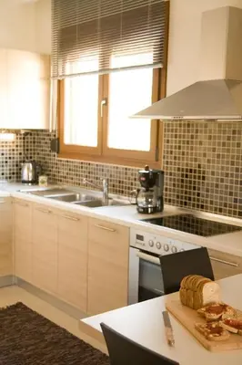 a kitchen with a sink and a table with bread on a cutting board at Executive Rhodes Villa 4 Bedroom 4 Bathroom Bd Villa Pefkos in Pefki Rhodes